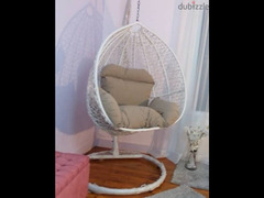 Rattan swing chair with pillows